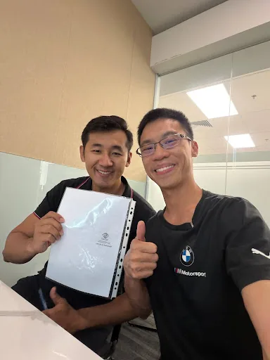 Wilfred with Dishi, holding the signed documents