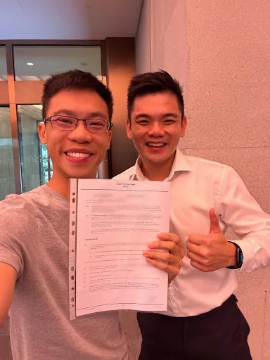 Wilfred with KW, holding the signed agreement